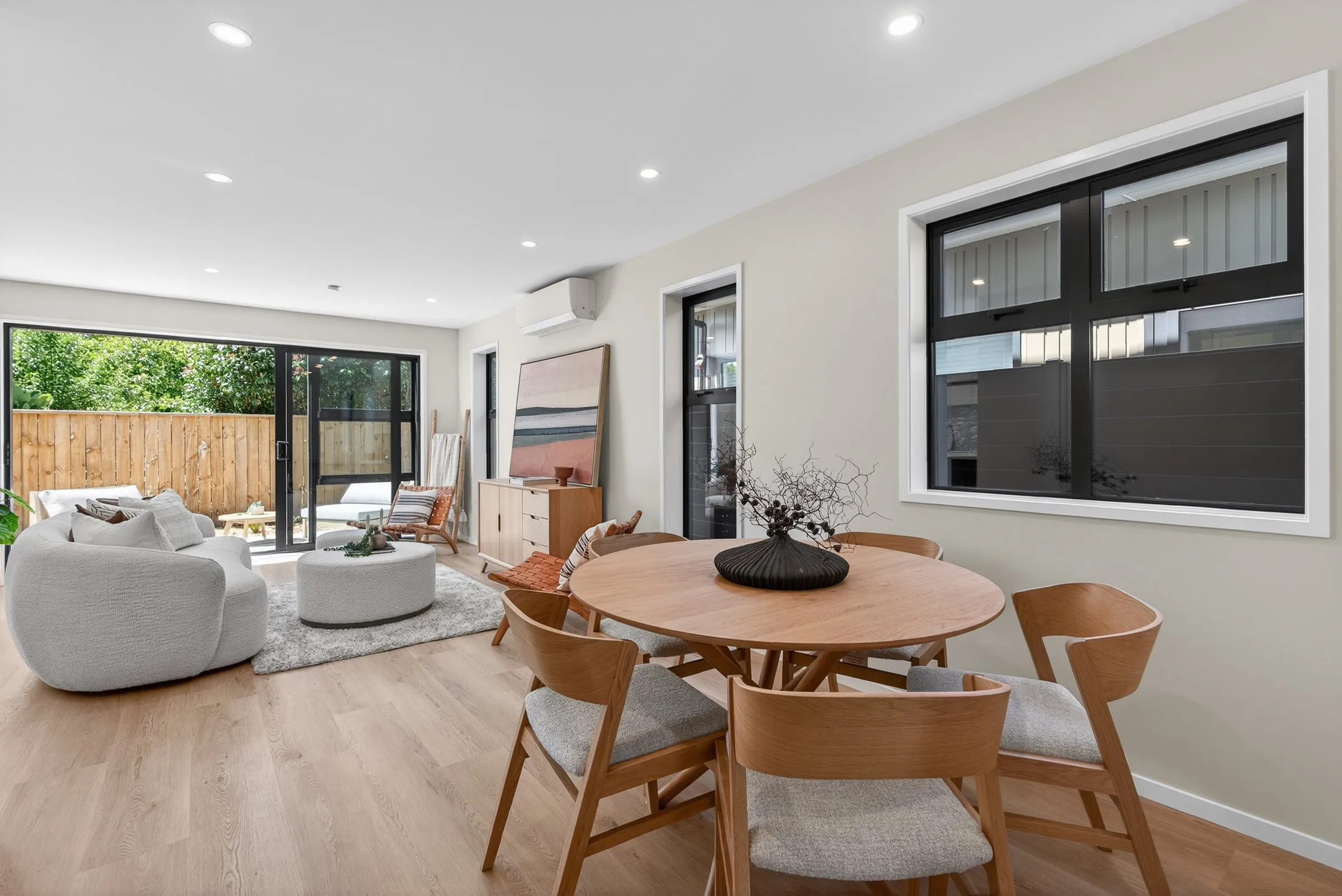 Open plan living and dining with floor to ceiling windows