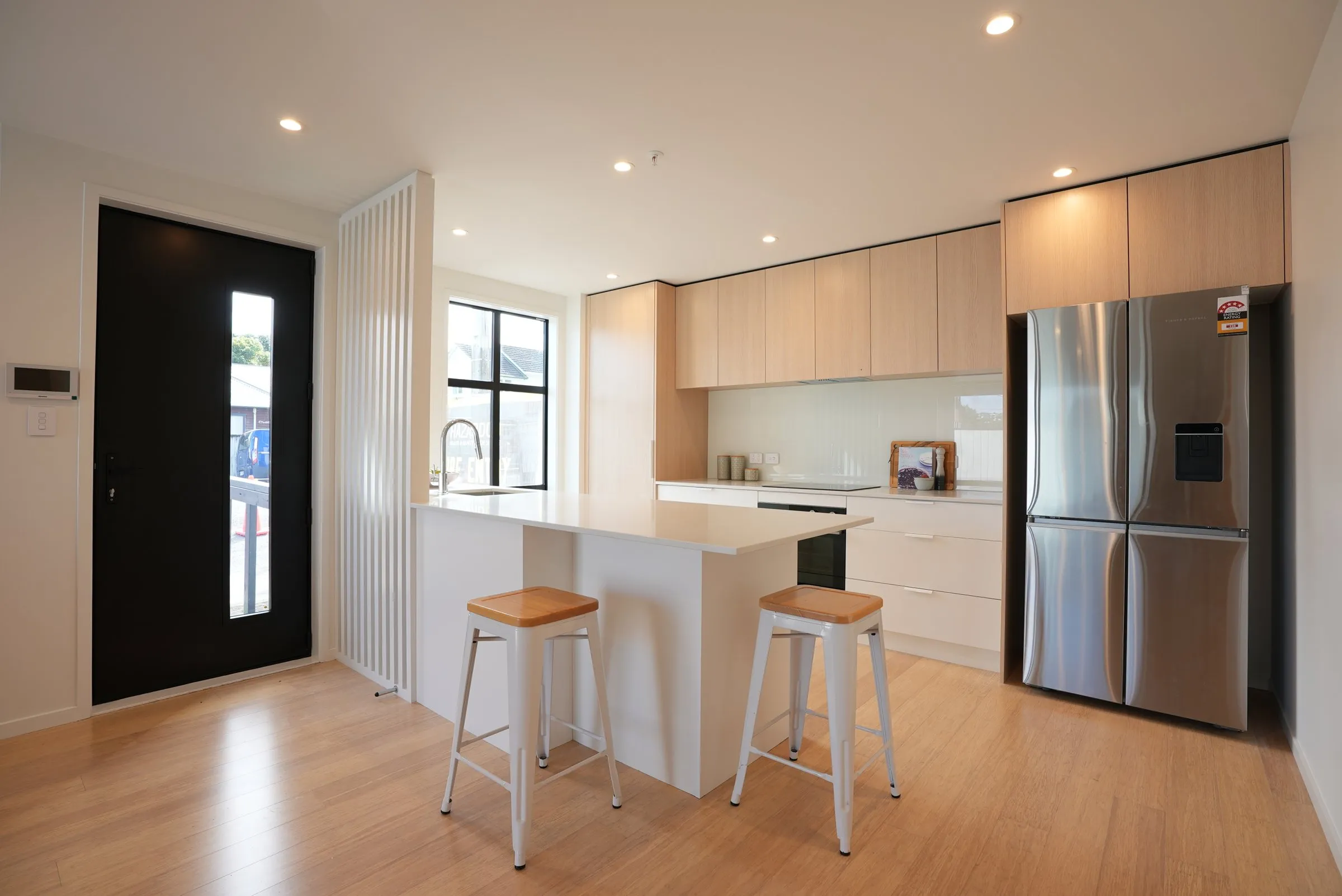Kitchen with island bench and stools