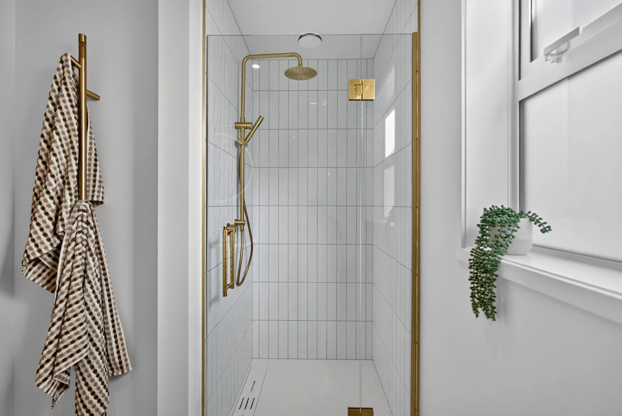 Tiled shower with brushed gold fittings