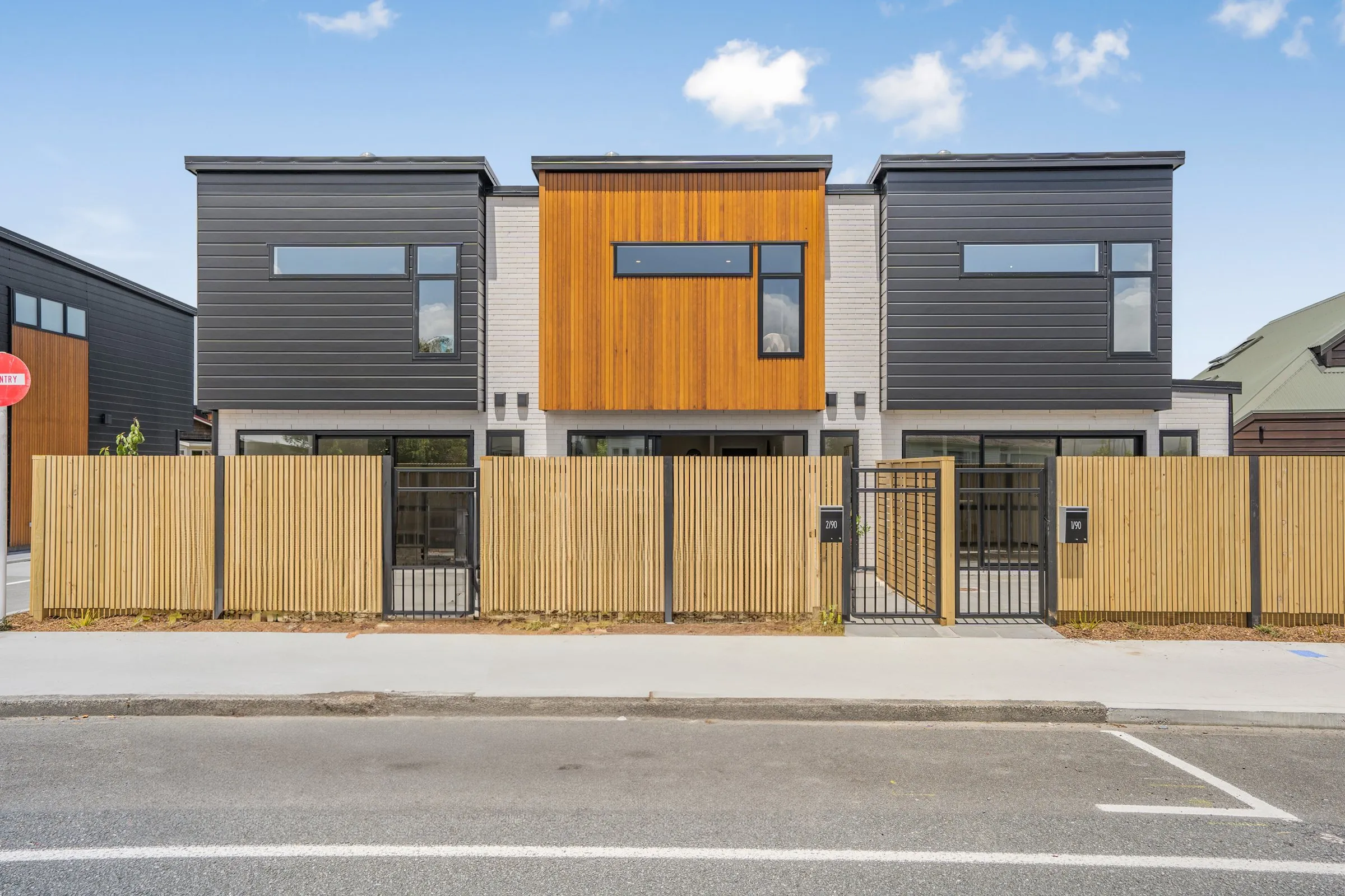 Hautana Lane townhouses behind timber fencing, with cedar and dark cladding